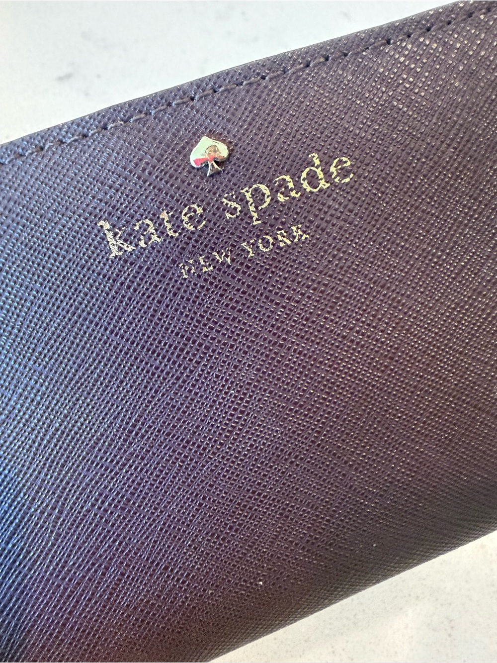 kate spade plum textured leather zip wallet with gold logo